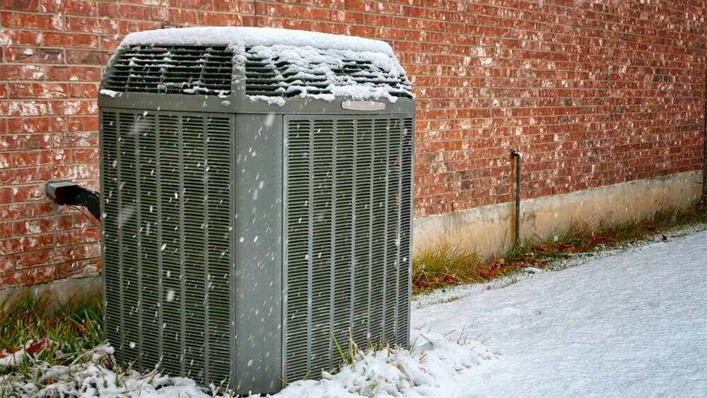 heat pump covered in snow